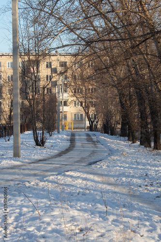 Snow-covered road to the house running along the edge of the Park.