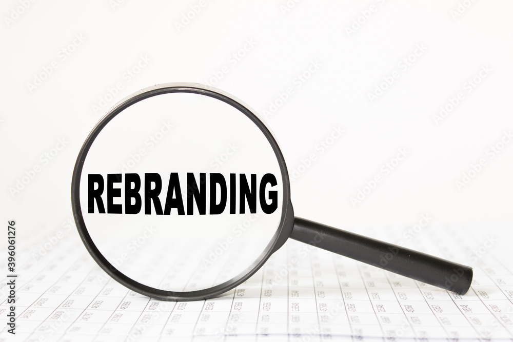 words REBRANDING in a magnifying glass on a white background. business concept words REBRANDING in a magnifying glass on a white background. business concept