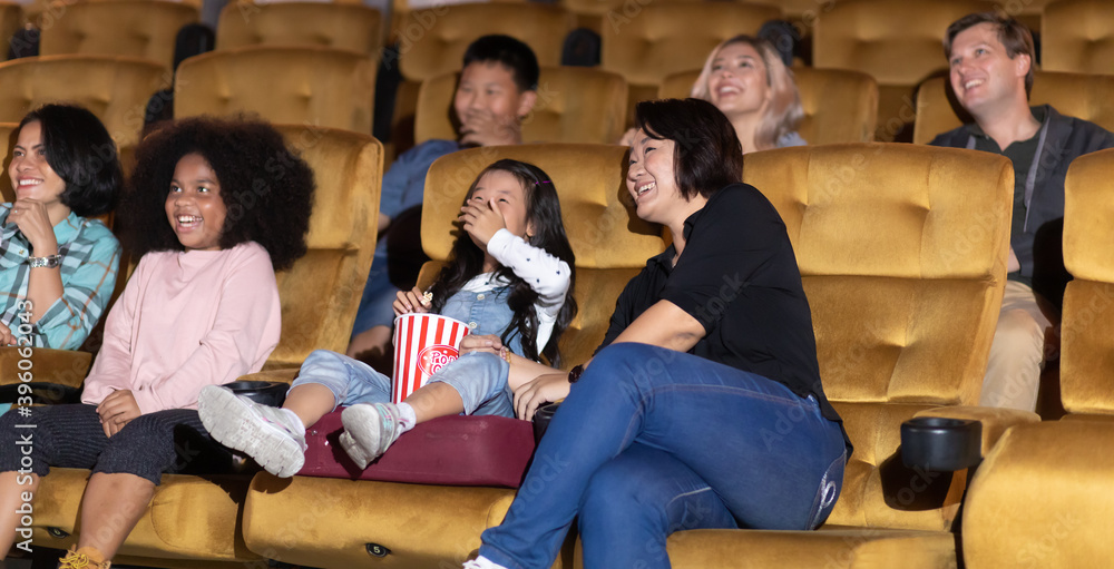 Happy family watching movie in cinema theatre. Happy family time in holiday Happy family watching movie in cinema theatre. Happy family time in holiday