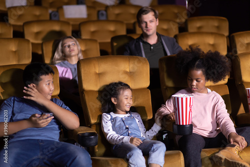 Happy family watching movie in cinema theatre. Happy family time in holiday