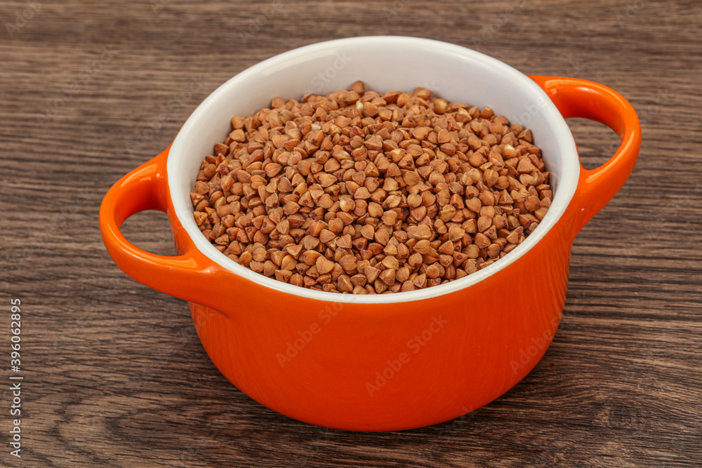 Raw buсkwheat cereal in the bowl Raw buсkwheat cereal in the bowl