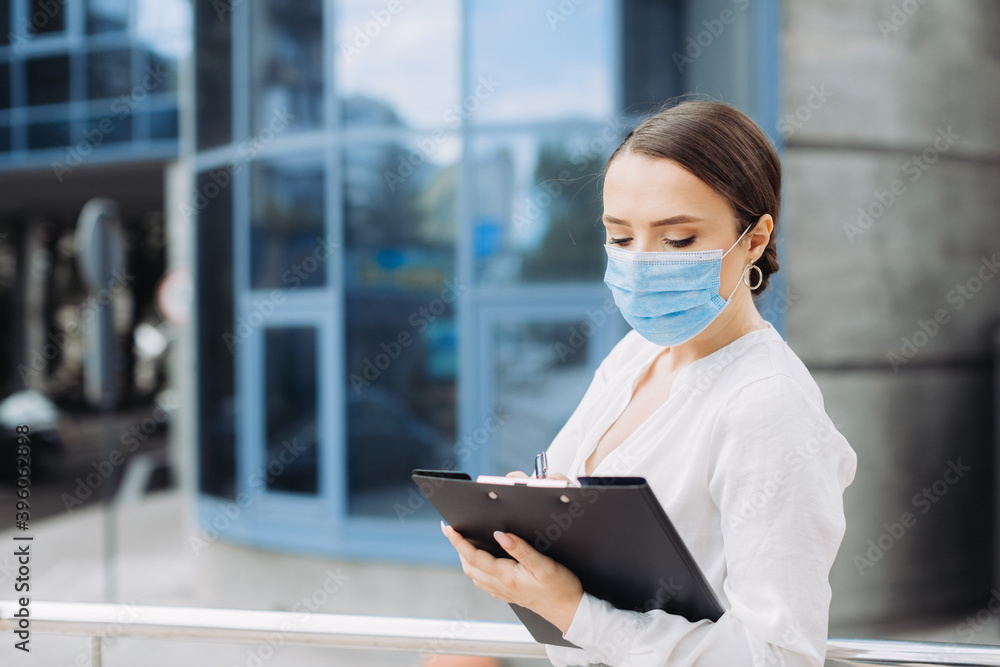 business woman wearing protection mask a holding paper holder in the business district business woman wearing protection mask a holding paper holder in the business district