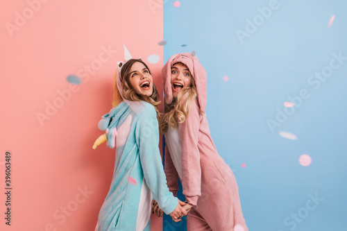Print op canvas Emotional girl wears pink kigurumi laughing to camera