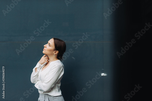 Portrait of happy business woman standing on street.