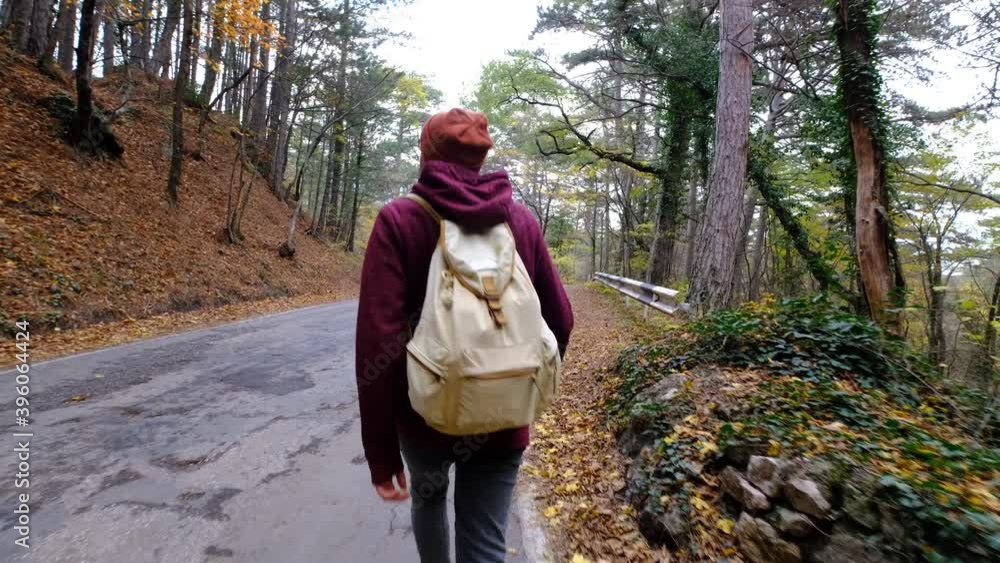 Young man Hiking in Forest in Autumn. Active healthy Caucasian man with a backpack taking in wood. Young man Hiking in Forest in Autumn. Active healthy Caucasian man with a backpack taking in wood.
