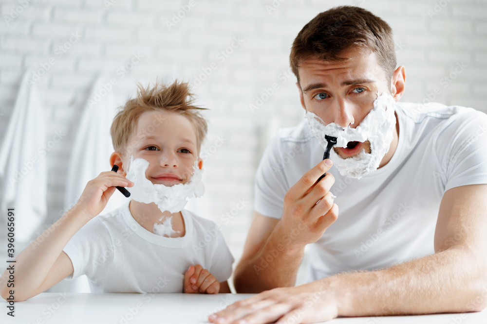 Father and his little son shaving together Father and his little son shaving together