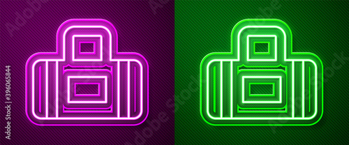 Glowing neon line Sport bag icon isolated on purple and green background. Vector.