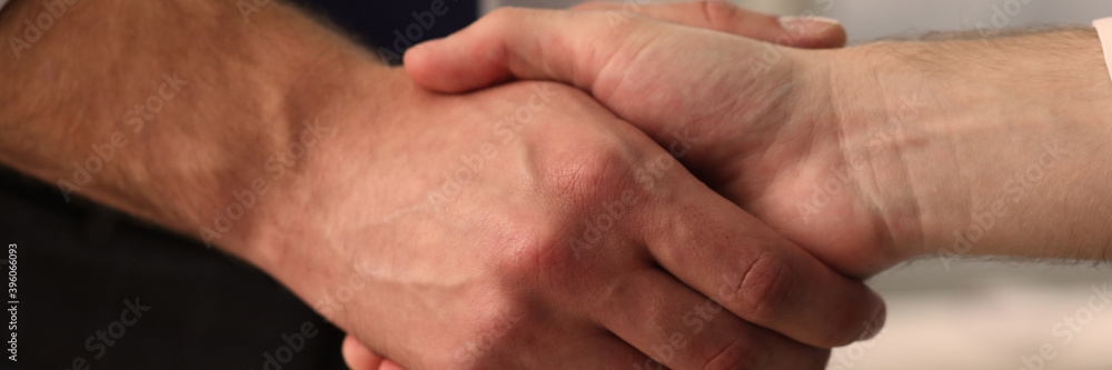 Close up of professional business partners that being satisfied with the agreement of their meeting Close up of professional business partners that being satisfied with the agreement of their meeting