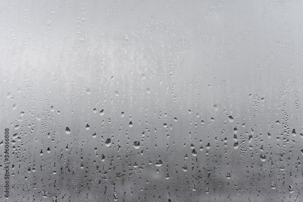 Dripping Condensation, Water Drops Background Rain drop Condensation Texture. Close up for misted glass with droplets of water draining down Dripping Condensation, Water Drops Background Rain drop Condensation Texture. Close up for misted glass with droplets of water draining down