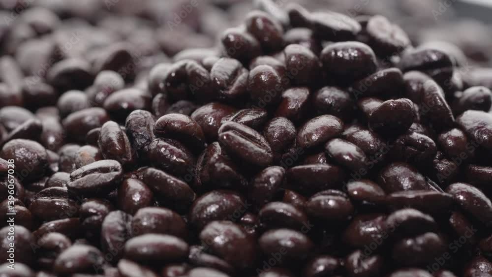 Closeup of roasted coffee beans on rotating table. Aromatic coffee grains are turning.
Closeup of roasted coffee beans on rotating table. Aromatic coffee grains are turning.