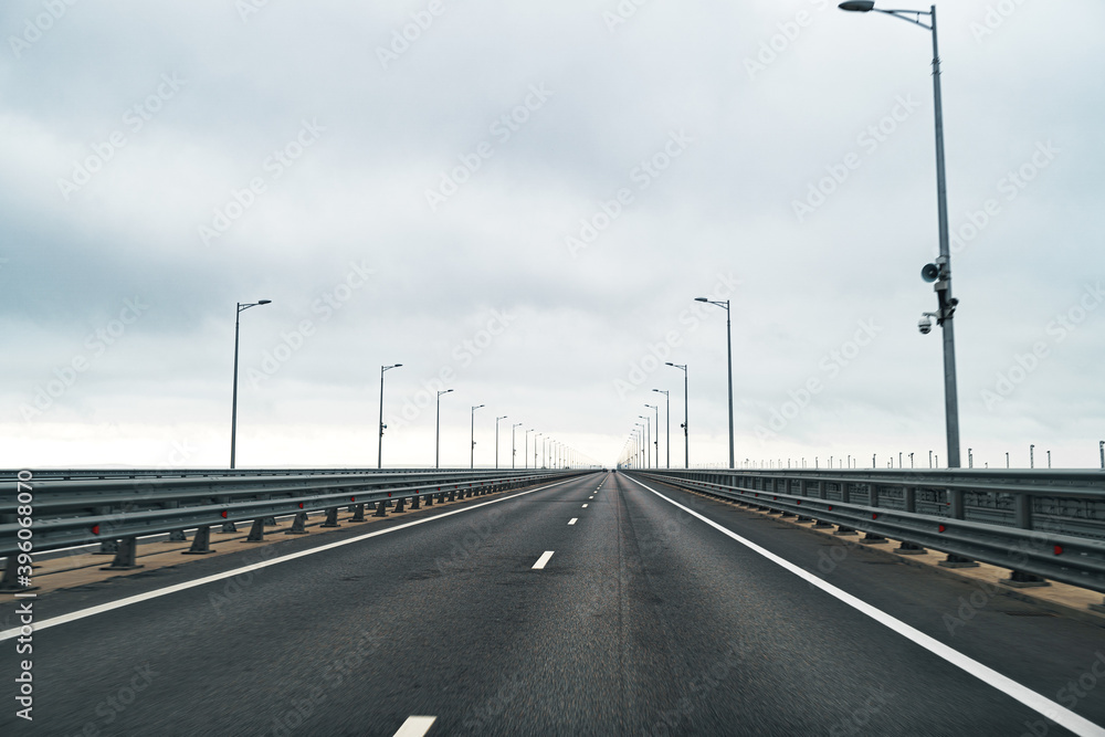 Empty highway with asphalt road and cloudy sky Empty highway with asphalt road and cloudy sky