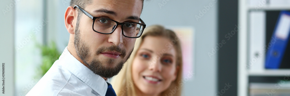 Silhouette of charming assistant that keeping smile on her face while standing near her colleague Silhouette of charming assistant that keeping smile on her face while standing near her colleague