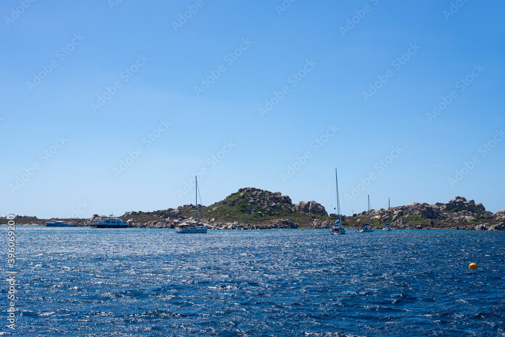 Naklejka premium view of boat in the open sea, calm and blue in the Mediterranean between France and Italy for a peaceful, calm and zen vacation