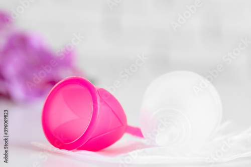 Two menstrual cups on table close up