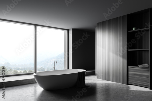 Gray and wooden bathroom corner with tub and window © ImageFlow