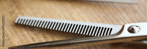 Macro picture of hairdressing scissors that lying on the table, being used for stylish haircut