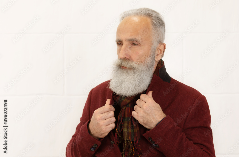 Handsome trendy mature bearded man on white background. Handsome trendy mature bearded man on white background.