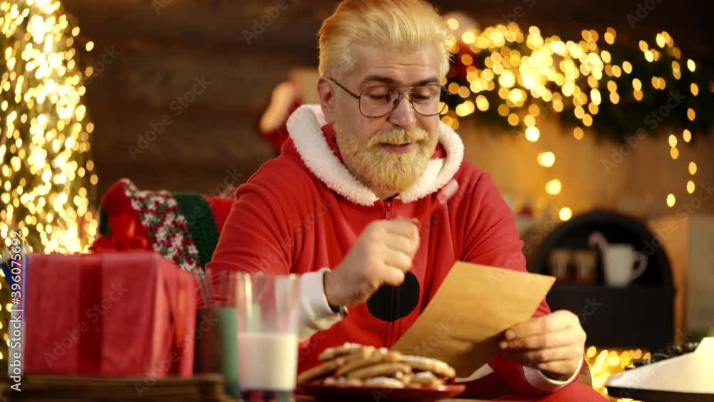 Crazy santa claus amazed impressed many receive wish list letters in house indoors with christmas x-mas lights decoration. Crazy santa claus amazed impressed many receive wish list letters in house indoors with christmas x-mas lights decoration.