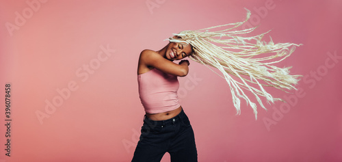 African american woman with long braided hair dancing
