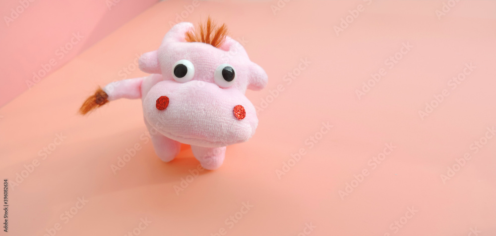 Cute soft pink bull figurine. New Year greeting card with free copy space for text. Chinese Year of Bull, Zodiac symbol 2021 Cute soft pink bull figurine. New Year greeting card with free copy space for text. Chinese Year of Bull, Zodiac symbol 2021