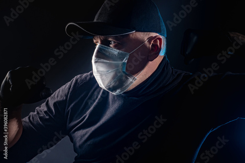 Man in medical mask clenche...
