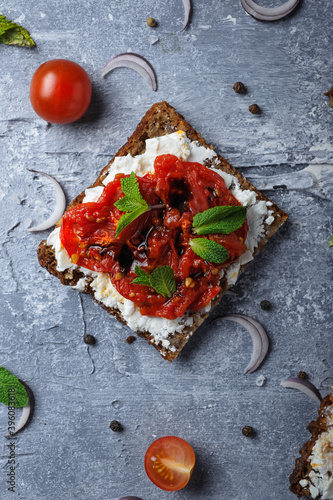 Bruschetta  with Fetaxa cheese and baked tomatoes photo