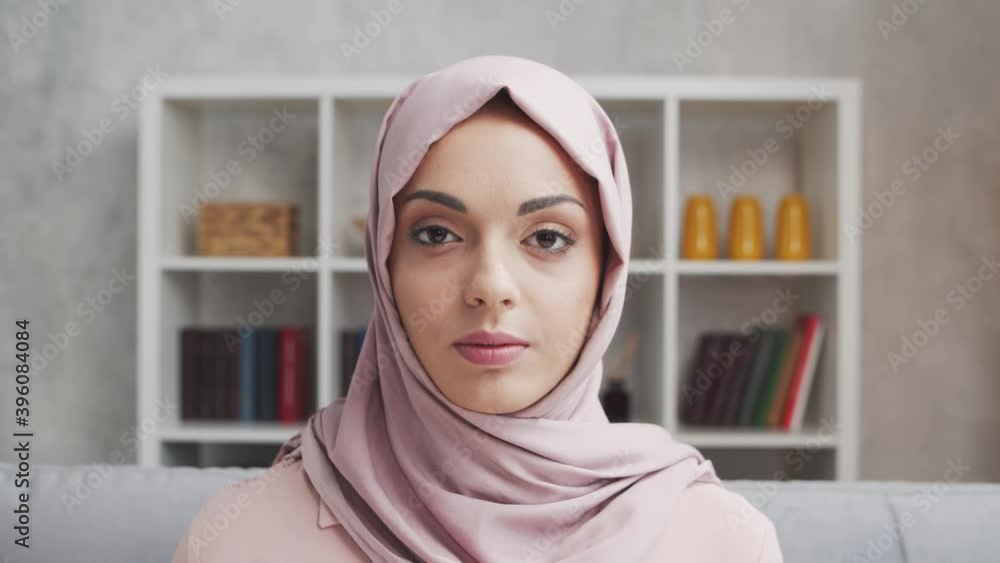 Close-up portrait of young and attractive muslim girl in hijab. Middle Eastern woman is sitting in front of the camera. Close-up portrait of young and attractive muslim girl in hijab. Middle Eastern woman is sitting in front of the camera.