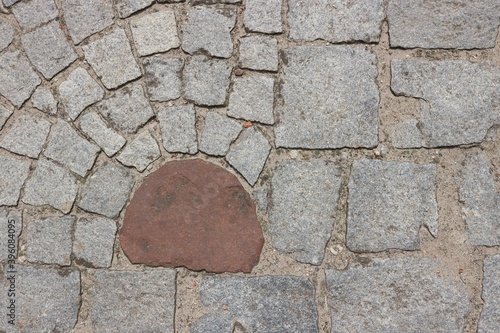fragment of a pavement lined with gray paving stones