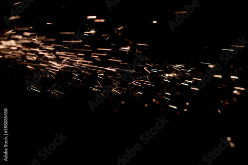 Glowing Flow of Sparks in the Dark. Fire sparks on a dark background