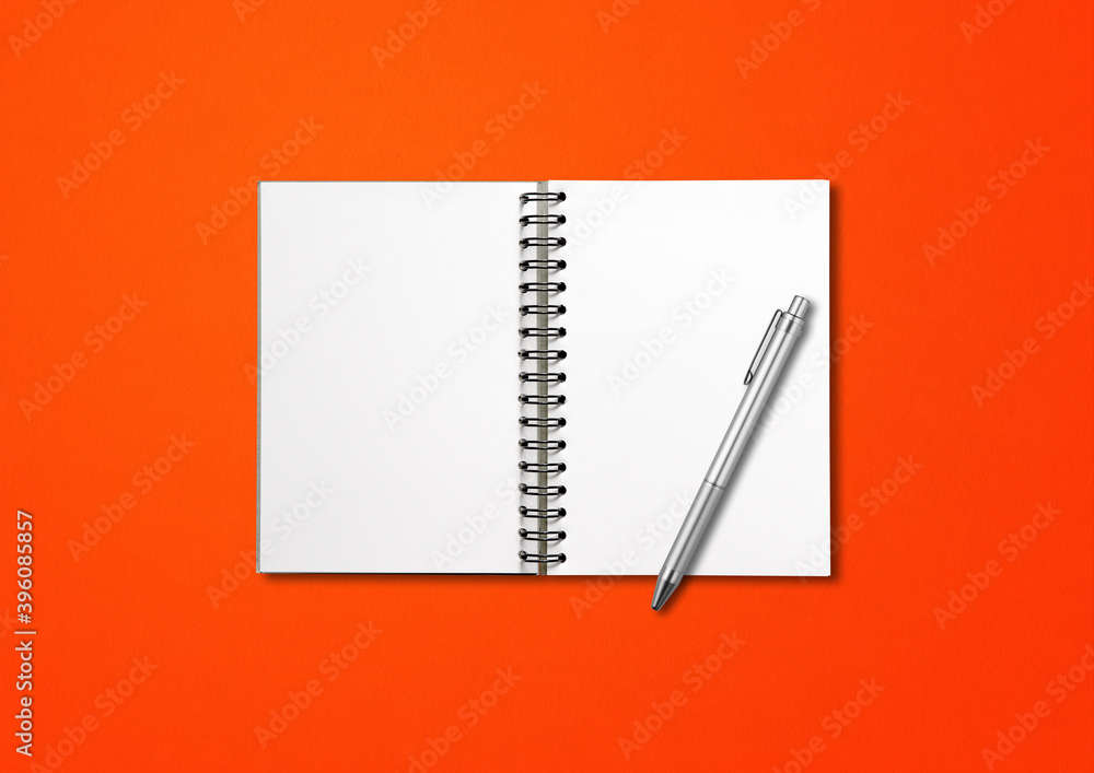 Blank open spiral notebook and pen isolated on red Blank open spiral notebook and pen isolated on red