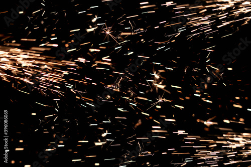 Glowing Flow of Sparks in the Dark. Fire sparks on a dark background