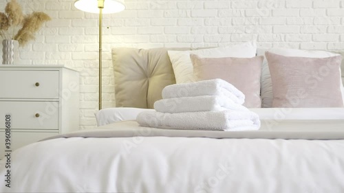 Clean towels on bed in hotel room