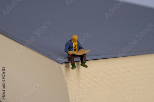 Small people reading on a book photo