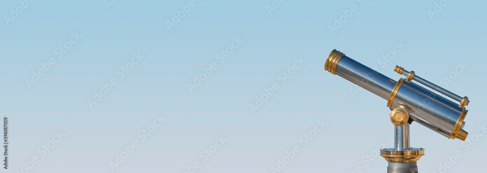 Banner with an old antique golden telescope at light blue sky background with copy space for text, details, closeup. Concept exploration, investigation and travel. Banner with an old antique golden telescope at light blue sky background with copy space for text, details, closeup. Concept exploration, investigation and travel.