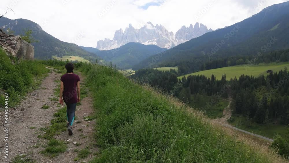 Aerial Hiker Above Quaint Town of St. Magdalena and Dolomite Mountains, Italy Aerial Hiker Above Quaint Town of St. Magdalena and Dolomite Mountains, Italy