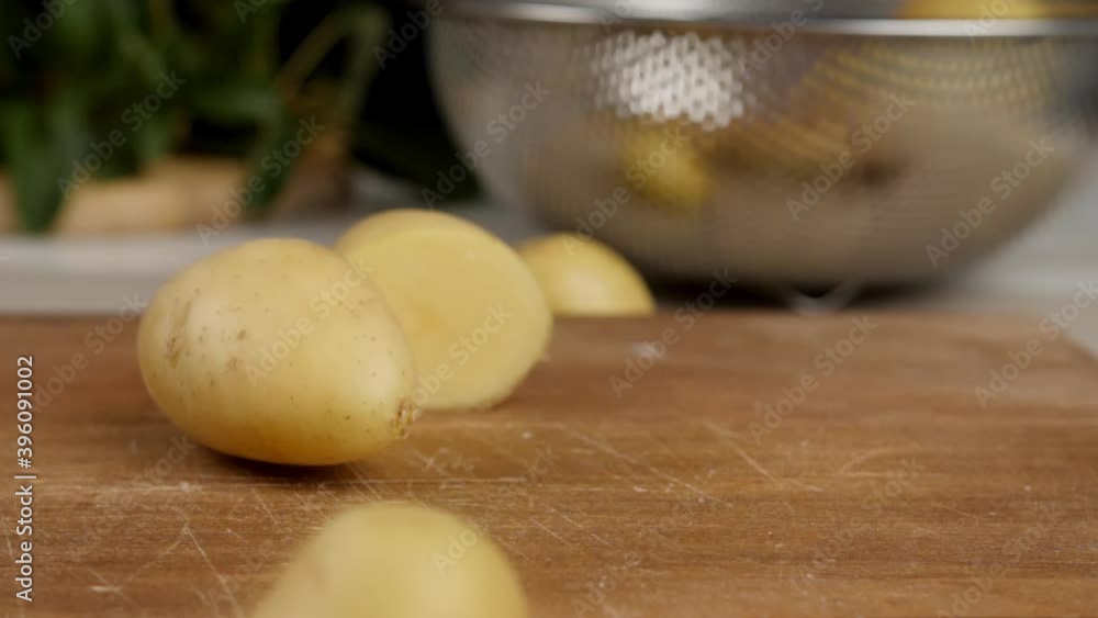 Cutting of fresh potatoes on table, closeup Cutting of fresh potatoes on table, closeup