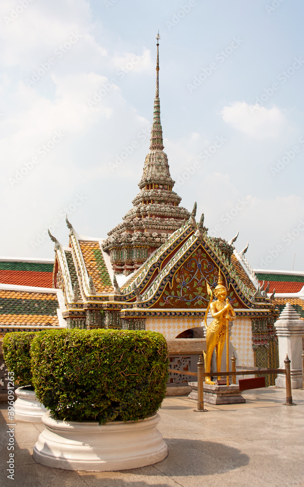 Golden statue of kinnara, mythical creature, in garden of Wat Phra Kaew temple within the Grand Palace complex, Bangkok, Thailand Golden statue of kinnara, mythical creature, in garden of Wat Phra Kaew temple within the Grand Palace complex, Bangkok, Thailand
