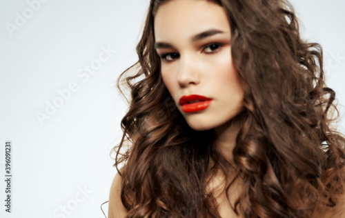 Pretty woman curly hair body care red lips close-up