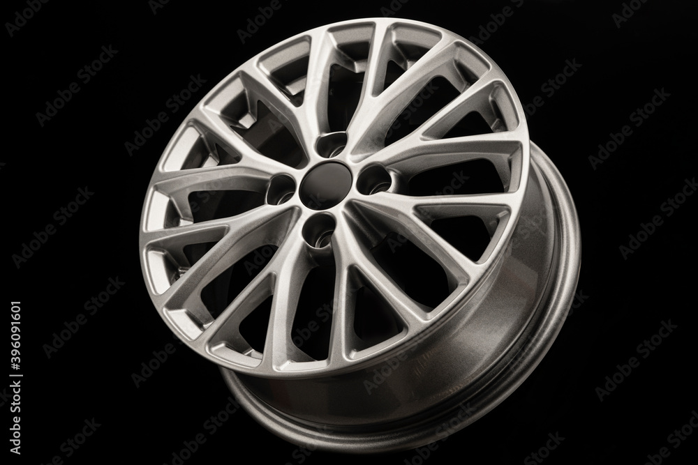new grey silver alloy wheel on black background