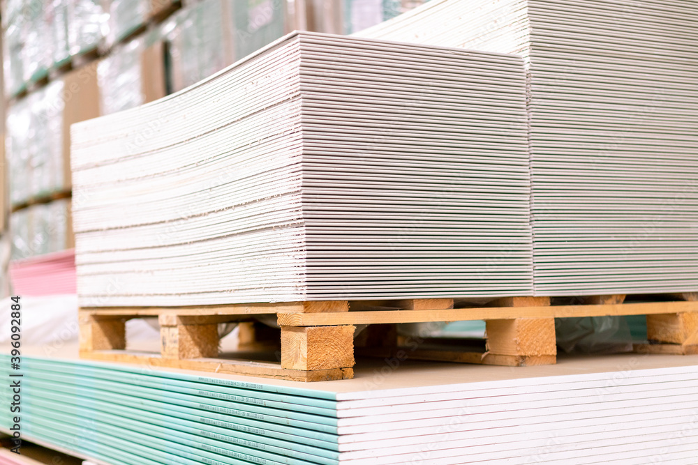 Pallet with Drywall sheets plasterboard in the building warehouse store