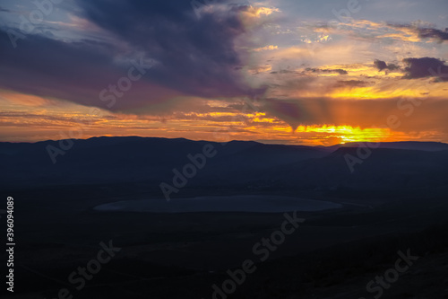Fototapeta Naklejka Na Ścianę i Meble -  sunset with views of mountains in Crimea. Blue mountains and bright yellow sun. landscape and beautiful background