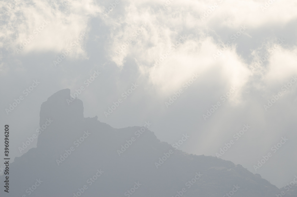 Silhouette of the Roque Bentayga backlighting and clouds. The Nublo Rural park. Tejeda. Gran Canaria. Canary Islands. Spain.