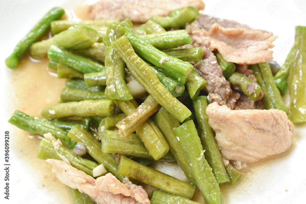 stir fried slice yard long bean with pork on soy sauce on plate stir fried slice yard long bean with pork on soy sauce on plate