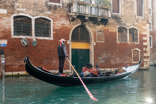 Venice, Italy - October 31 2020: Gondola with tourists on Venice canal