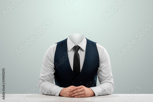 Businessman in a white shirt, vest and headless tie on a light background. Copy space. photo