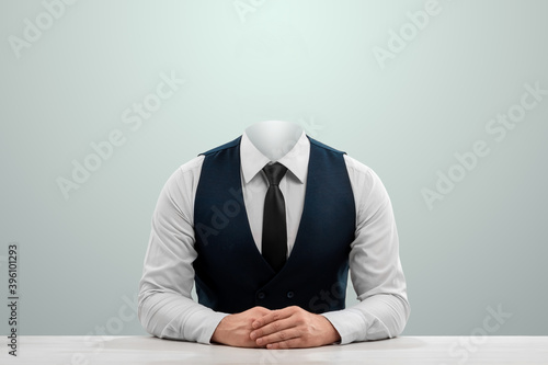 Businessman in a white shirt, vest and headless tie on a light background. Copy space.