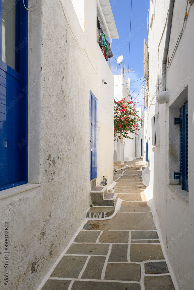 A narrow street in the old town of Chora. The inscription on the stairs in English: Love. Ios Island. Greece
