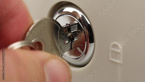 human try to open lock of safe or cash drawer with key, gets stuck and it is difficult to turn the key in the lock, lock is broken or the mechanism is defective, close-up view
