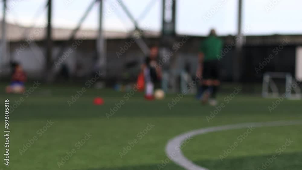 blurry kid soccer team training. Blurry soccer player training with coach in soccer academy. blurry kid soccer team training. Blurry soccer player training with coach in soccer academy.