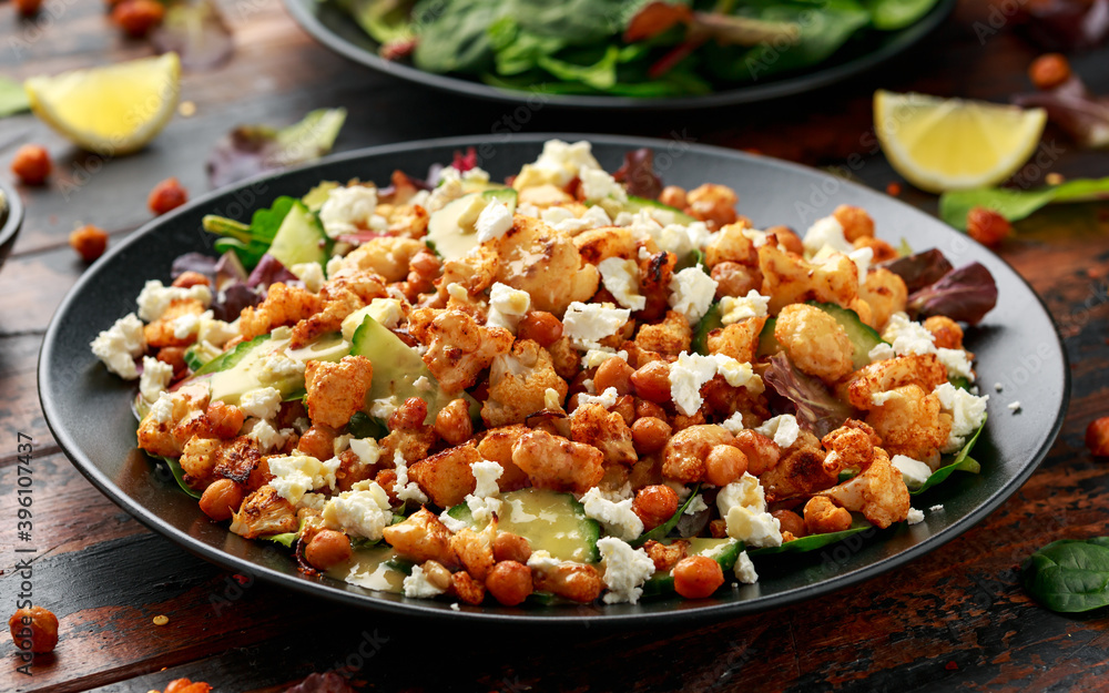 Roasted Cauliflower salad with chickpea, cucumber, greens and feta cheese. healthy food Roasted Cauliflower salad with chickpea, cucumber, greens and feta cheese. healthy food